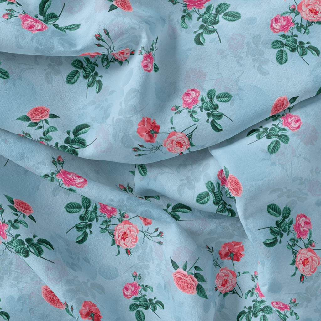 A beautifully woven handloom dress with soft pastel hues and a floral pattern, highlighting the intricate craftsmanship of handloom dresses. The fabric features delicate roses and leafy vines, creating an elegant and timeless look. The texture appears lightweight and breathable, making it ideal for traditional and contemporary styling.